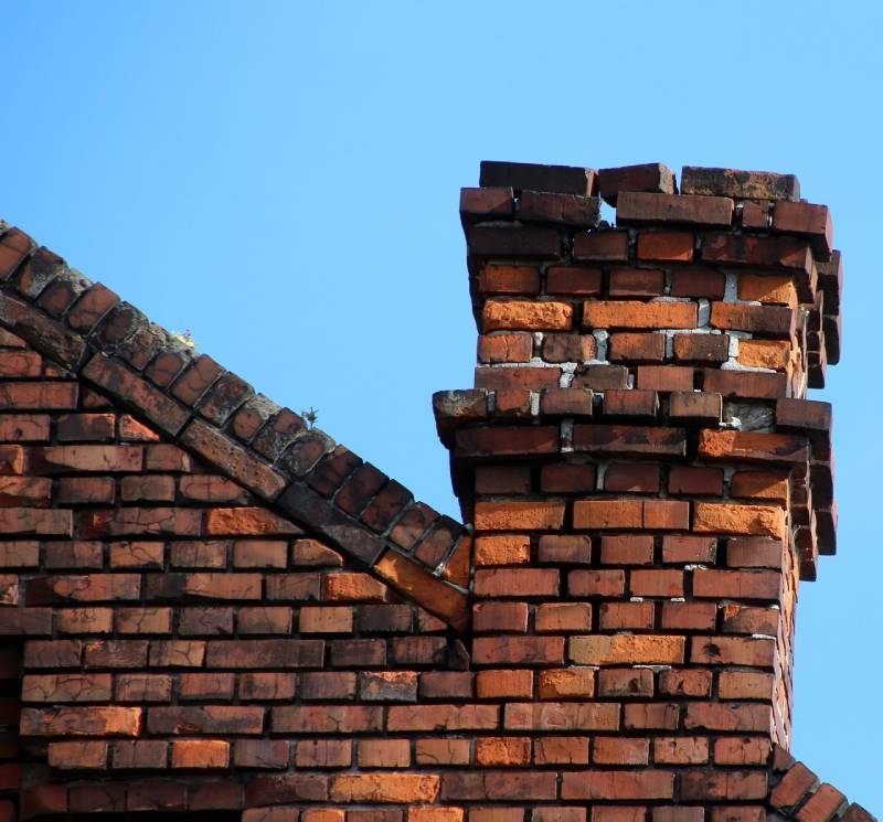 Signs Your Carol Stream Home Needs a Chimney Inspection Damaged chimney on an Carol Stream home showing cracks and missing mortar